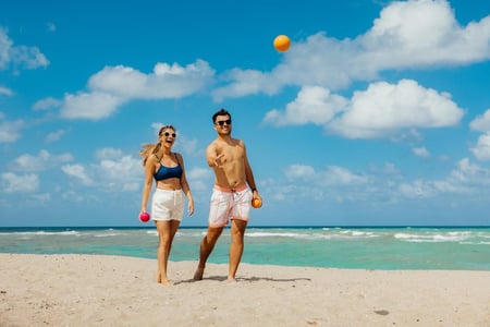 Couple Playing Bocce on the Beach - 2026 (Emergent) Visit Florida