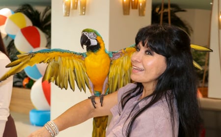 f24018e2379f0bafea724c0c8b7fb026 Margaritaville Resort Woman and Parrot