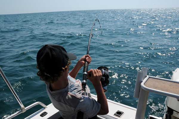 Boy fishing from boat