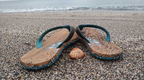 Flip flops and shell on the beach