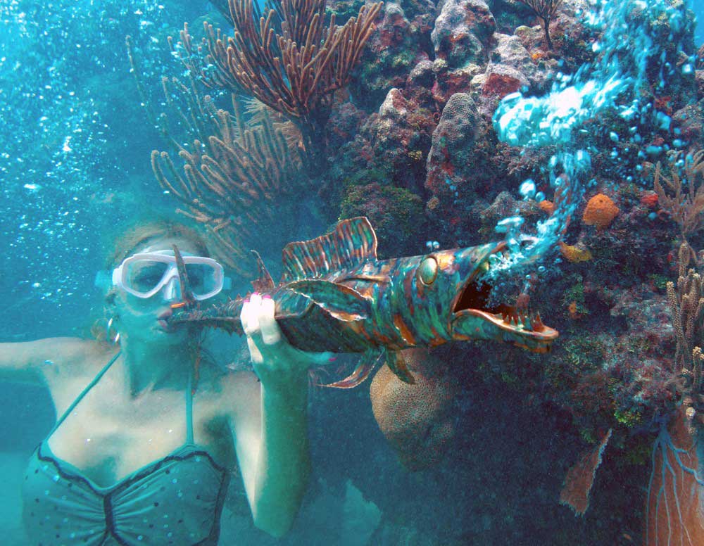 Woman playing a horn underwater