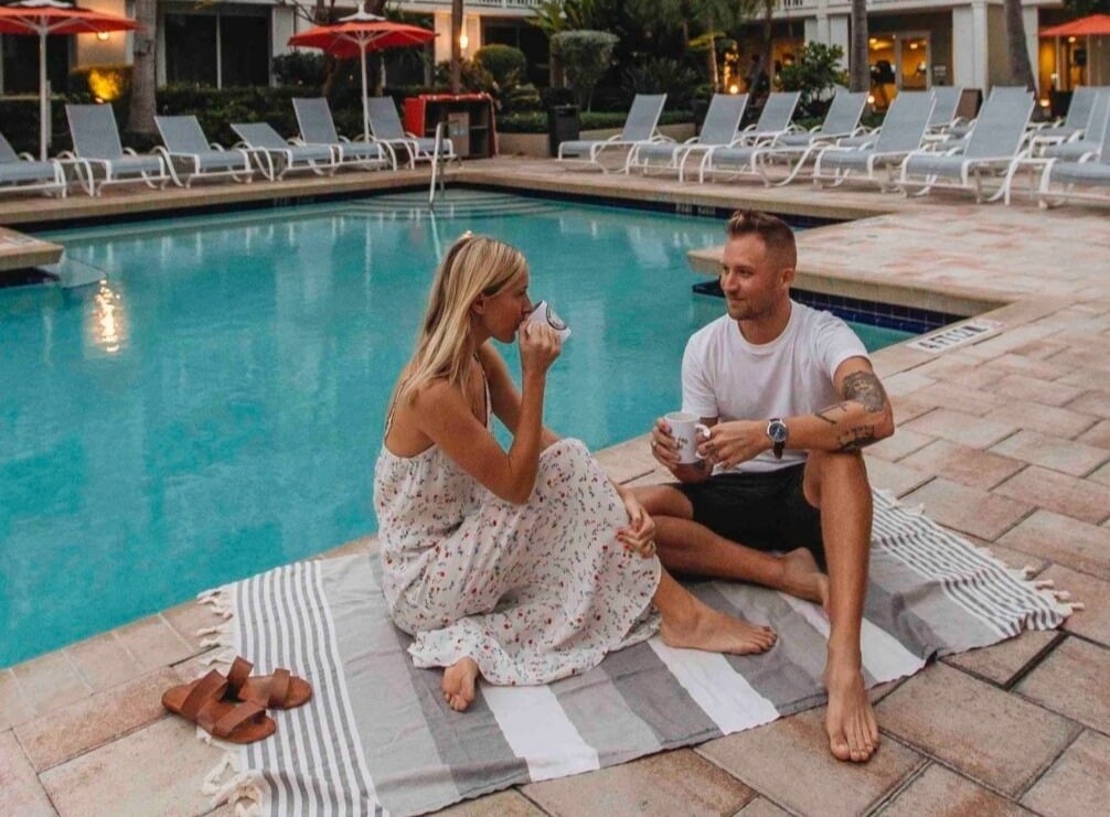 Couple sitting at the pool at the Opal Key Resort & Marina in Key West Florida