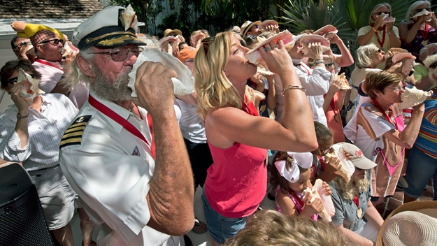 Blowing conch shells at the annual conch shell blowing contest